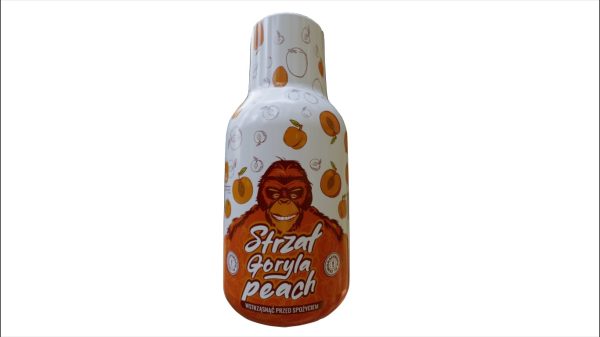 Strzał Goryla Peach - zbliżenie na buteleczkę shotu konopnego z dołączoną miarką
