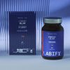 LABIFY Energy Power+ - zdjęcie 4 LABIFY Energy Power+ - butelka obok pudełka za falistą szybą w niebieskim świetle