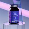 LABIFY Gut Shield - zdjęcie 5 LABIFY Gut Shield - butelka na przezroczystym podeście w różowo-niebieskim świetle